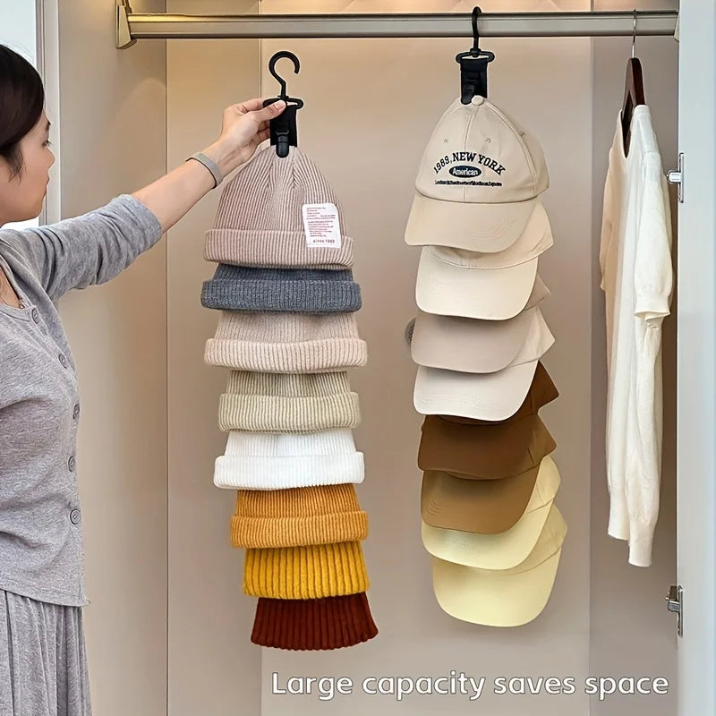 A woman is hanging a stack of layered beige and neutral-colored hats on a rack inside a closet.