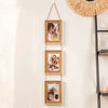 A vertical arrangement of three wooden photo frames hanging on a wall, featuring portraits of women.