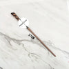 A brown metal magic wand replica with a decorative handle and a 37cm shaft resting on a white marble surface.