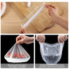 A clear elastic food cover is shown being stretched on a wooden board and sealed over a container for freshness and protectio