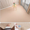 Close-up view of a self-adhesive solid color runner rug being applied to a wooden surface.
