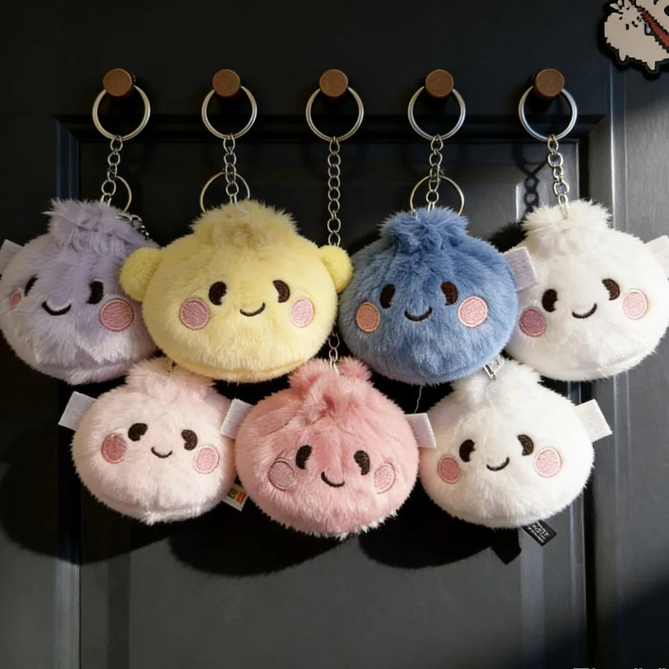 A display of various pastel-colored plush butter dumpling squishy keychains hanging on a dark door.