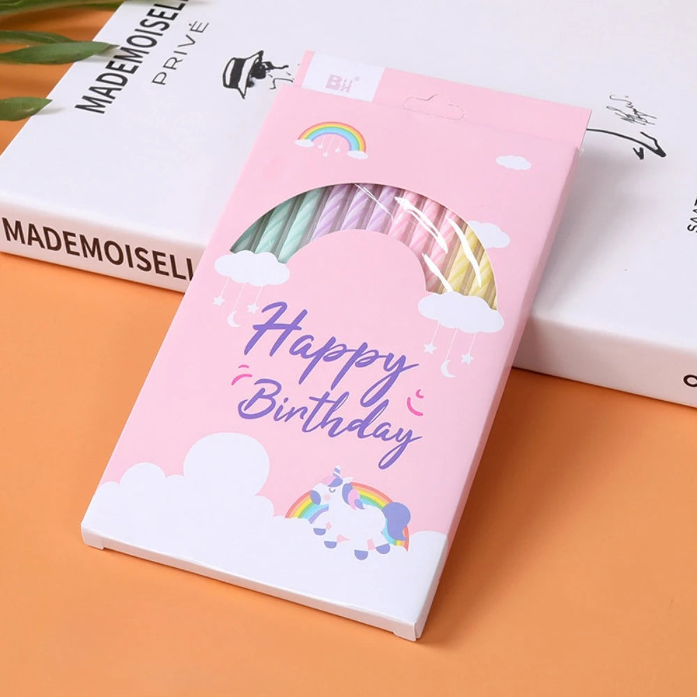 Pink birthday candles featuring a rainbow arch and clouds on a white background.