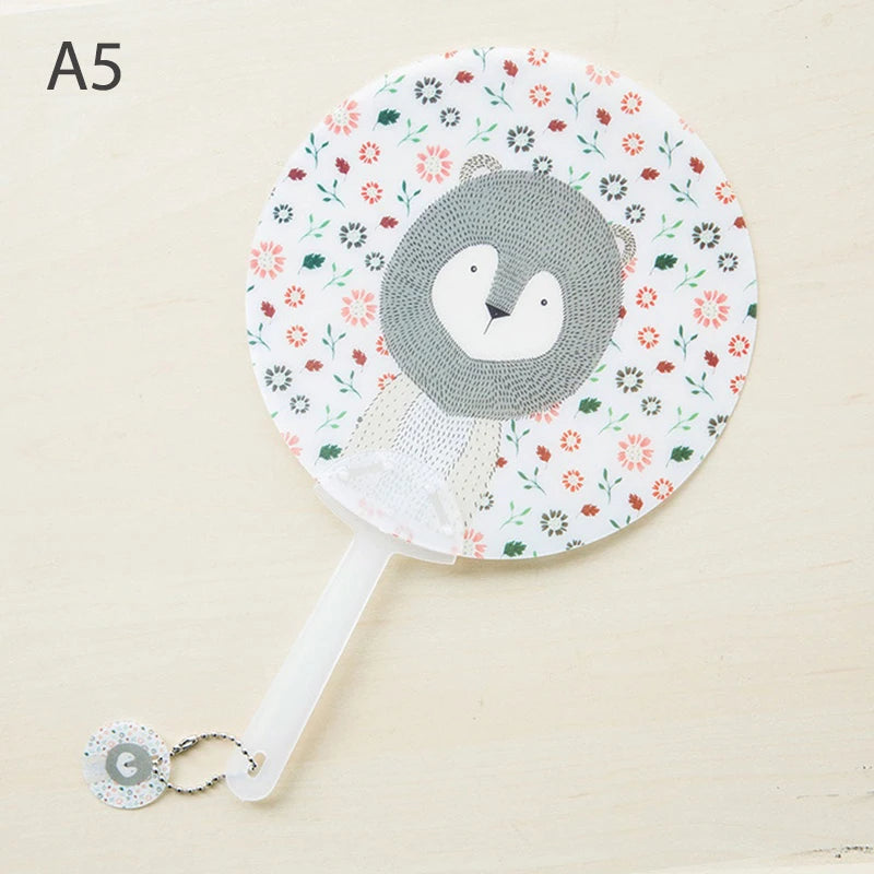 A lace folding hand fan featuring a gray bear face design with floral patterns.