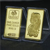 A gold-colored bullion ingot labeled SUISSE ONE OUNCE FINE GOLD 999.9 in a clear plastic holder.