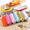 A set of mini foil bread trays and containers in various colors like yellow, pink, blue, and gold are displayed on a beige cl