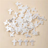 A pile of white acrylic cross shape beads for DIY jewelry making