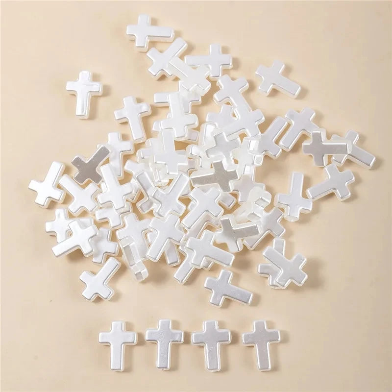 A pile of white acrylic cross shape beads for DIY jewelry making