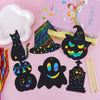 A set of black Halloween-themed scratch art cards featuring colorful rainbow designs and a purple vanilla ice cream box.