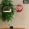 Vintage metal round stop sign wall decor with a red background and white text on a light beige wall.