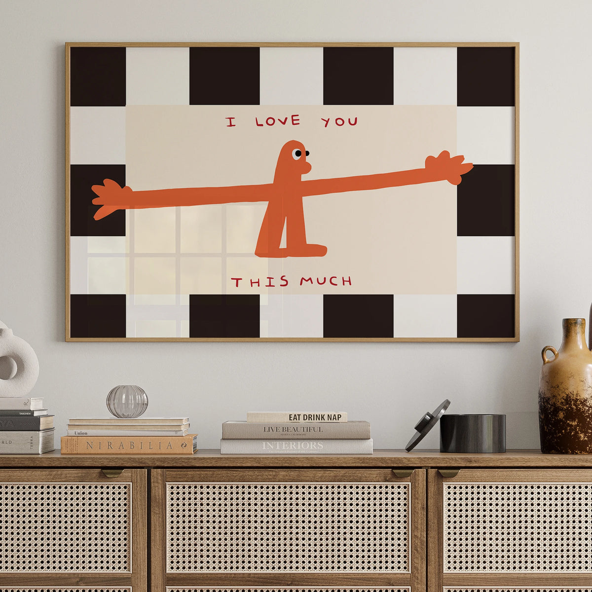 A framed wall art print featuring an orange silhouette of a figure saying I love you this much on a black and white checkered