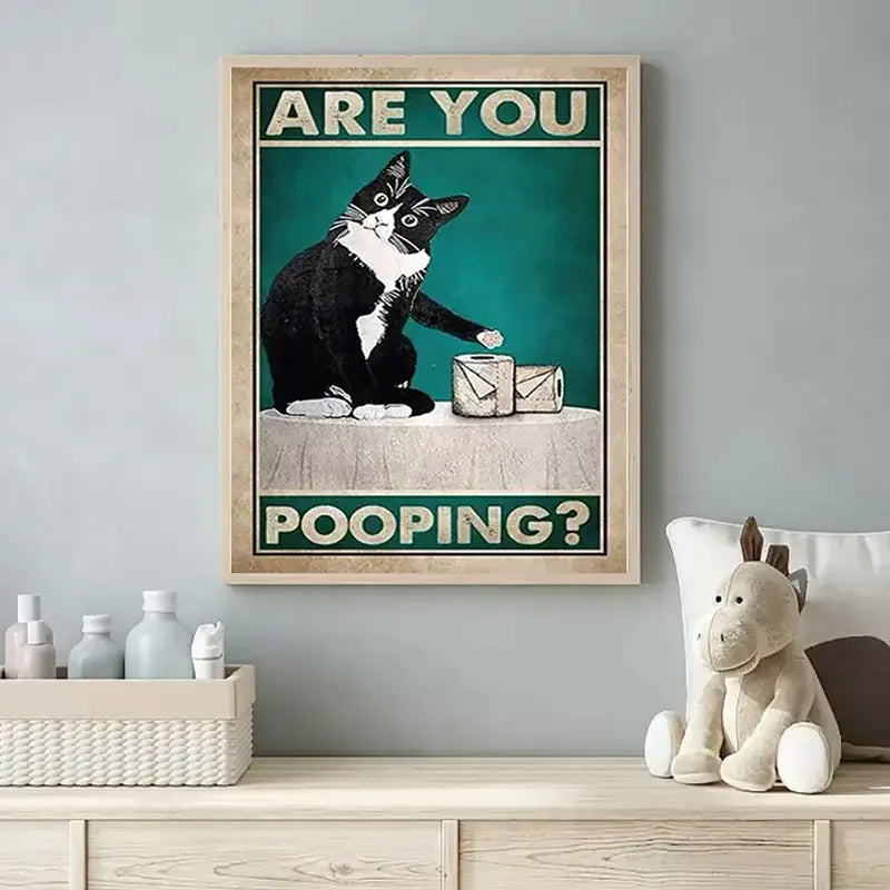 A framed poster featuring a black and white cat looking at the viewer with the text Are You Pooping?