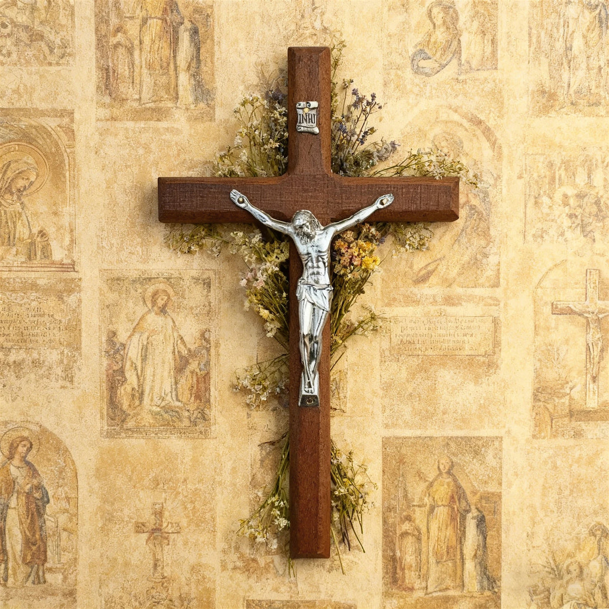 A handcrafted wooden cross with a silver crucifix and dried floral wreath mounted on a textured parchment background.