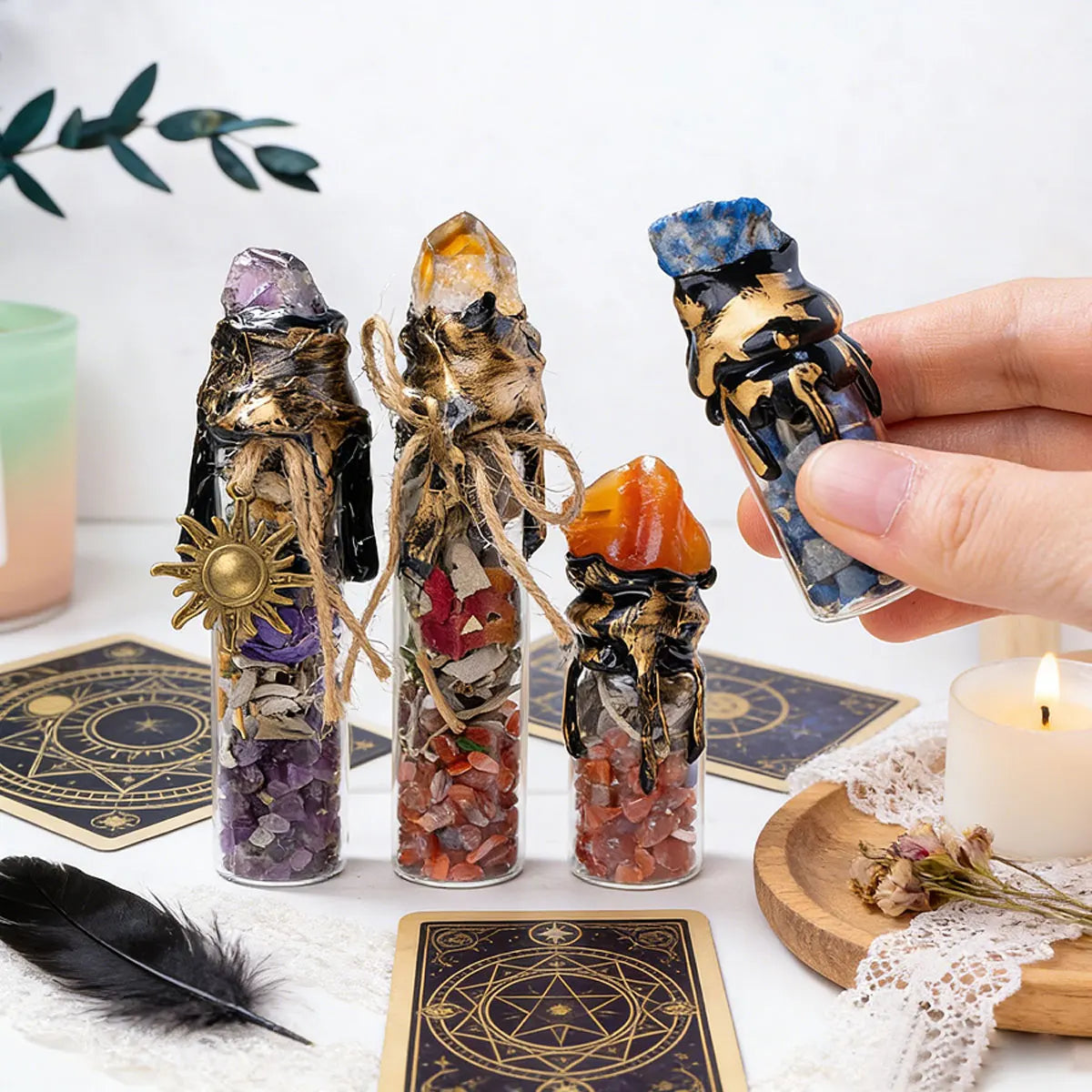 Three glass bottles filled with natural crystals and raw stones displayed on a white surface.
