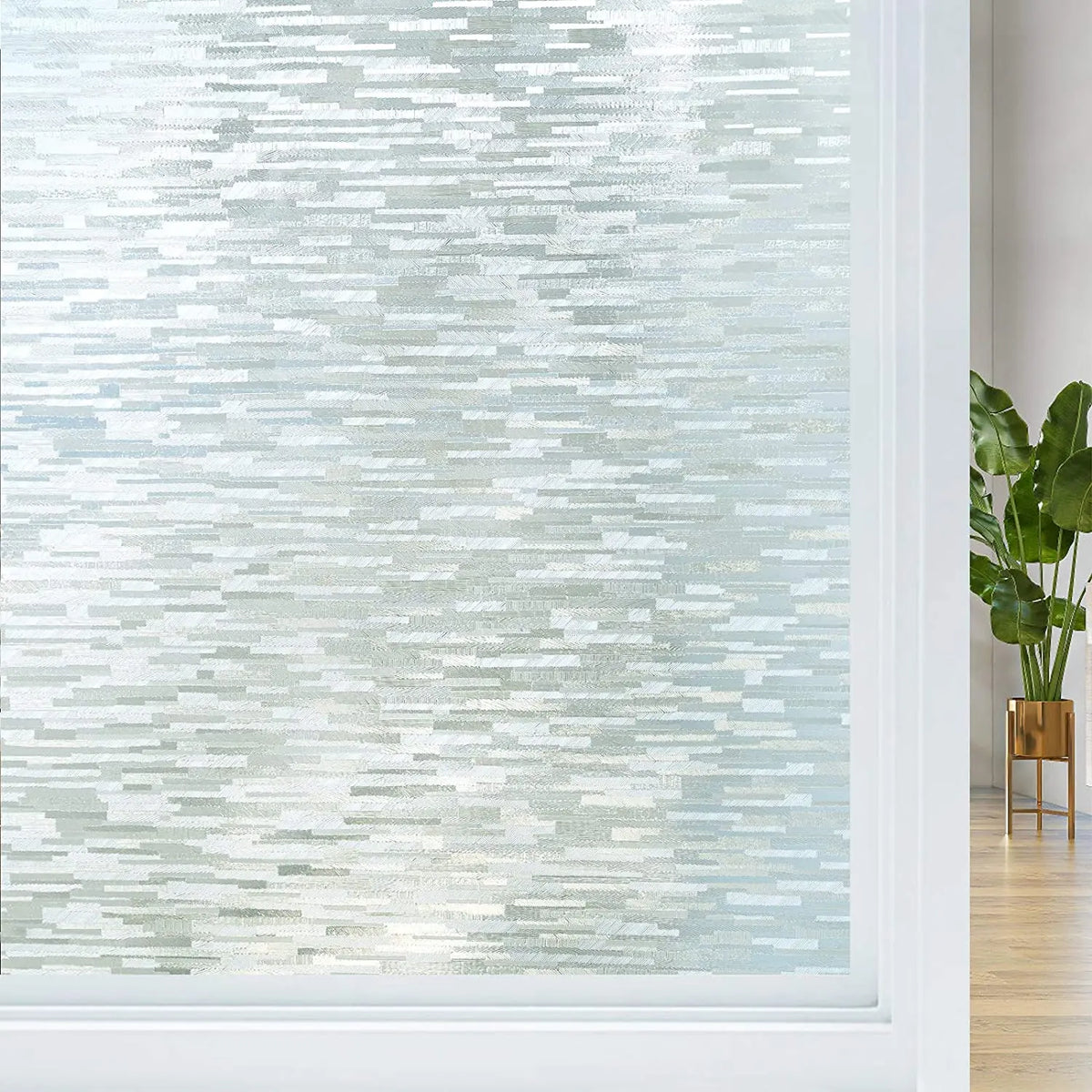 Close-up of frosted window privacy film with a light blue and white striated pattern.