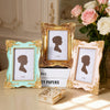 A set of three ornate gold and pastel-colored photo frames displaying silhouette portraits on white backgrounds.