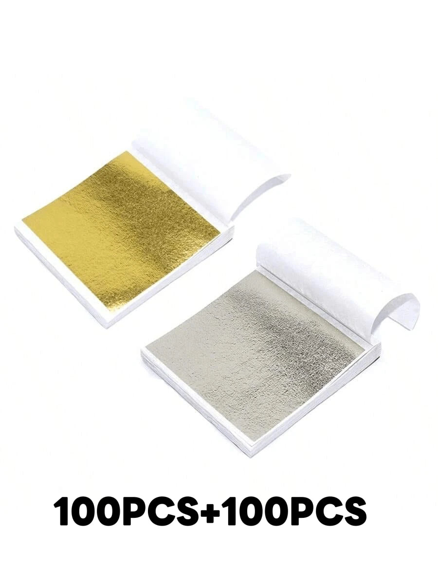 Two sheets of edible gold leaf flakes for baking and cake decoration displayed on a white background.