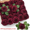 A box of deep burgundy foam rose flowers with green leaves for DIY bouquets and home decor