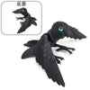 Black articulated 3D printed parrot figurine with movable wings shown from the back and side view.