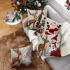 A set of four festive Christmas linen throw pillow covers featuring deer, reindeer, and Santa designs on a neutral background