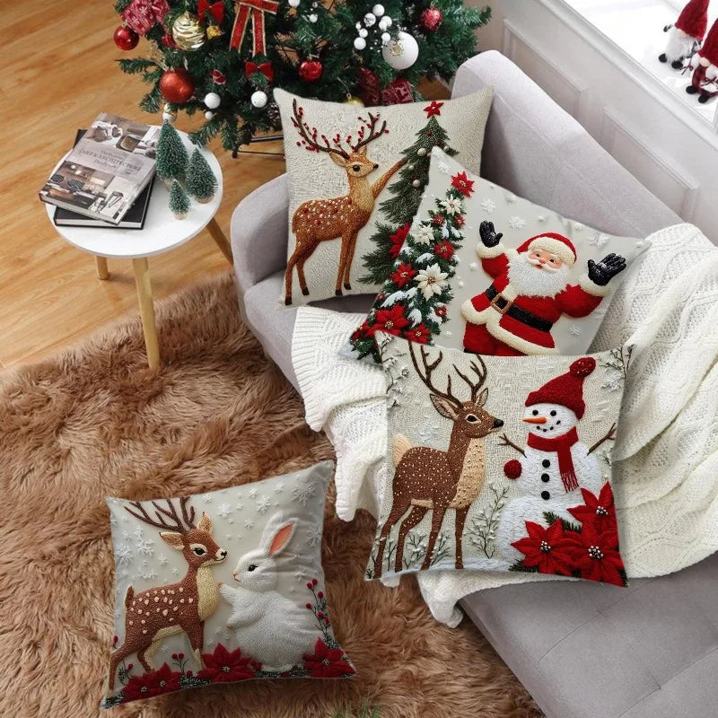 A set of four festive Christmas linen throw pillow covers featuring deer, reindeer, and Santa designs on a neutral background
