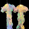 Two glowing jellyfish lanterns suspended against a black background