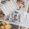 A white braided cotton wick is shown against a background of natural textures and food items.