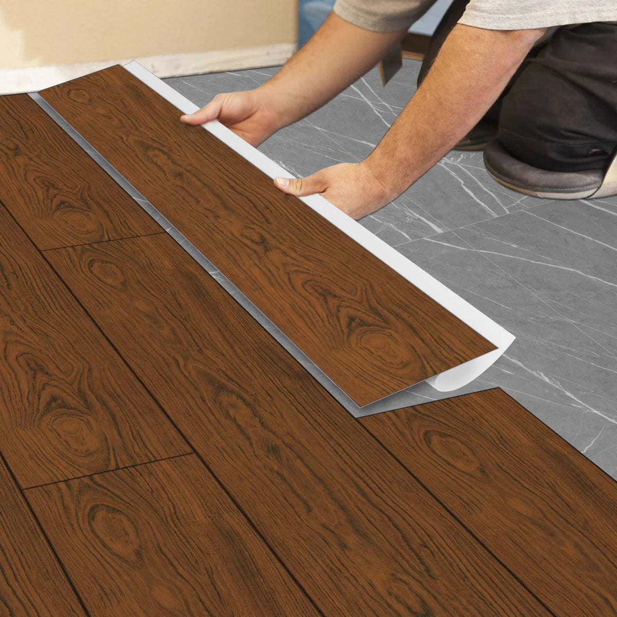 A person is applying wood grain self-adhesive decals to a floor, showing the texture and installation process.