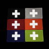A set of four rectangular tactical morale patches featuring a white cross on black, gray, red, and green backgrounds.