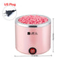 A pink compact wax warmer for hair removal, showing a lid filled with pink wax pellets and an electrical plug.