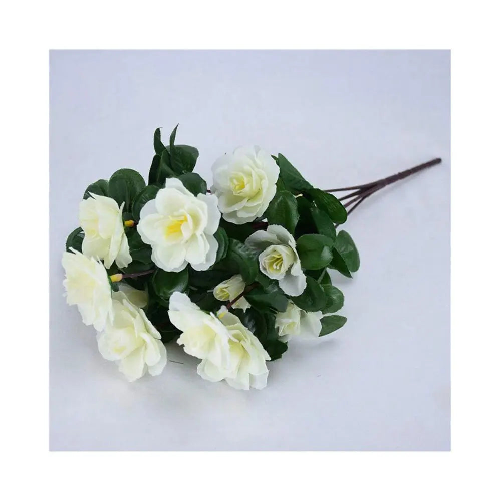 A bouquet of white artificial azalea flowers and green leaves for outdoor decoration