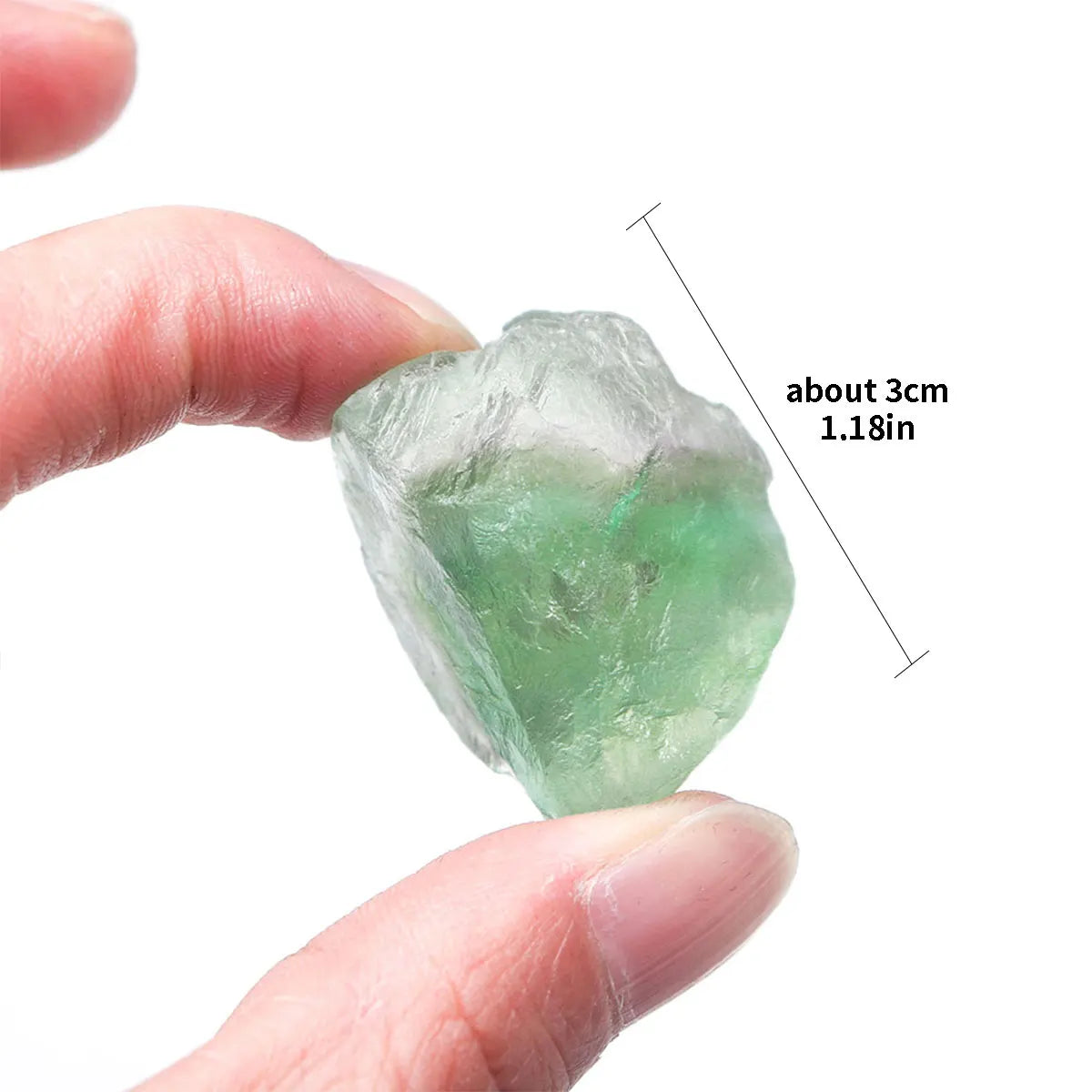 A hand holds a translucent green crystal healing stone, measuring about 3cm long.