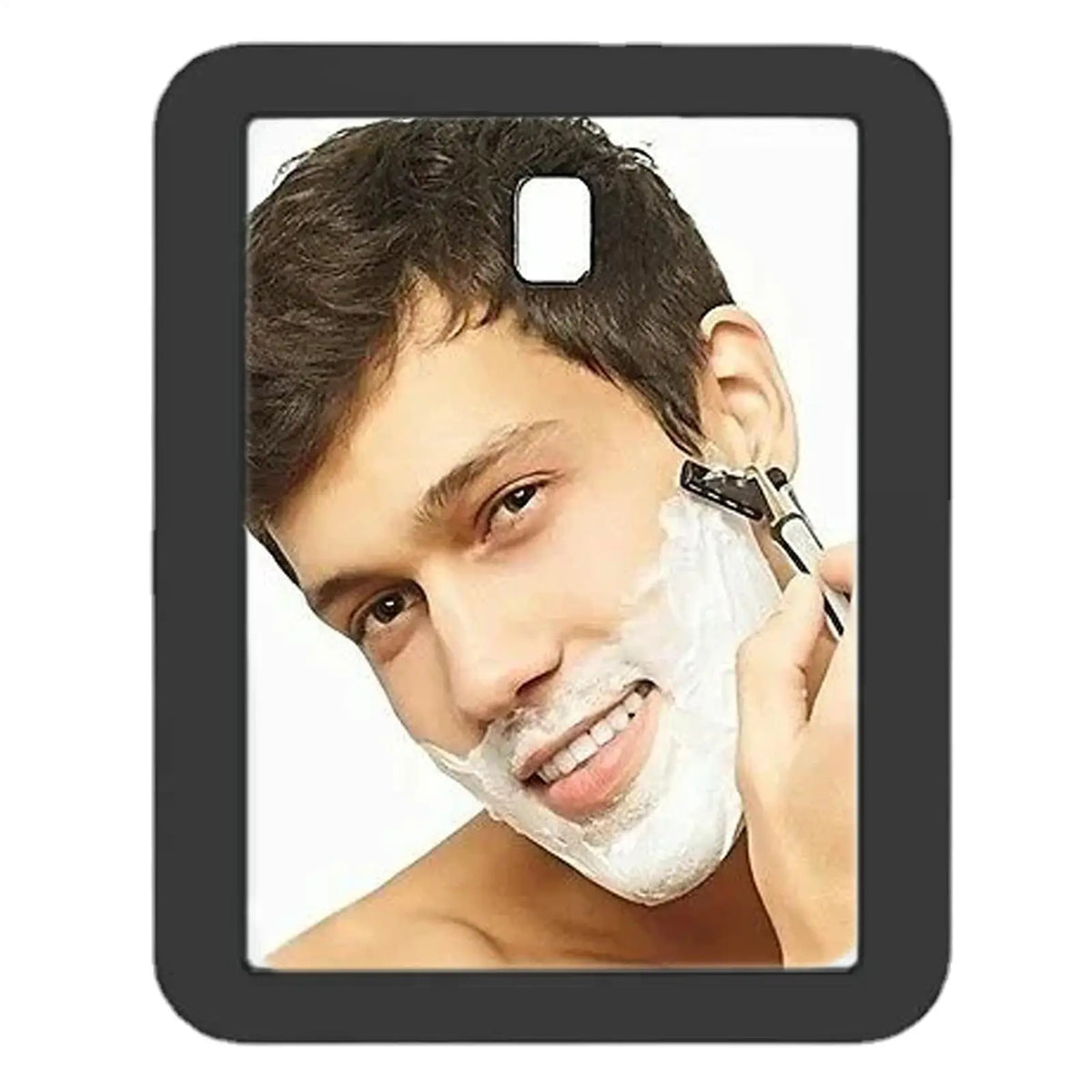 A man is shaving his face with a white foam on a compact magnetic locker mirror.
