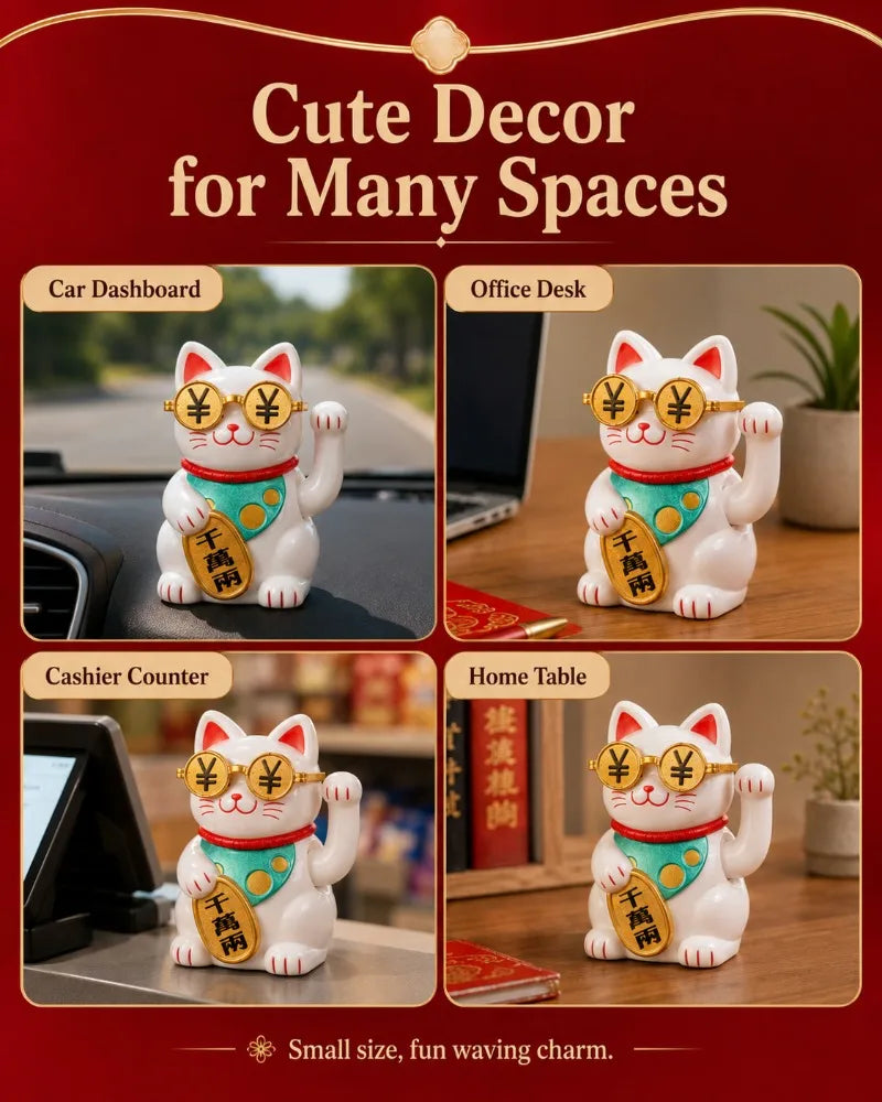 A white ceramic lucky cat ornament with red accents and gold coins sitting on a wooden desk.