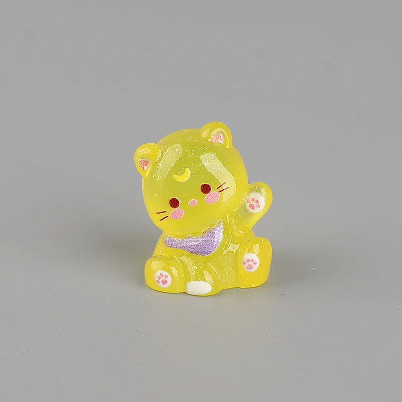 A yellow resin keychain shaped like a cute cat with pink accents.