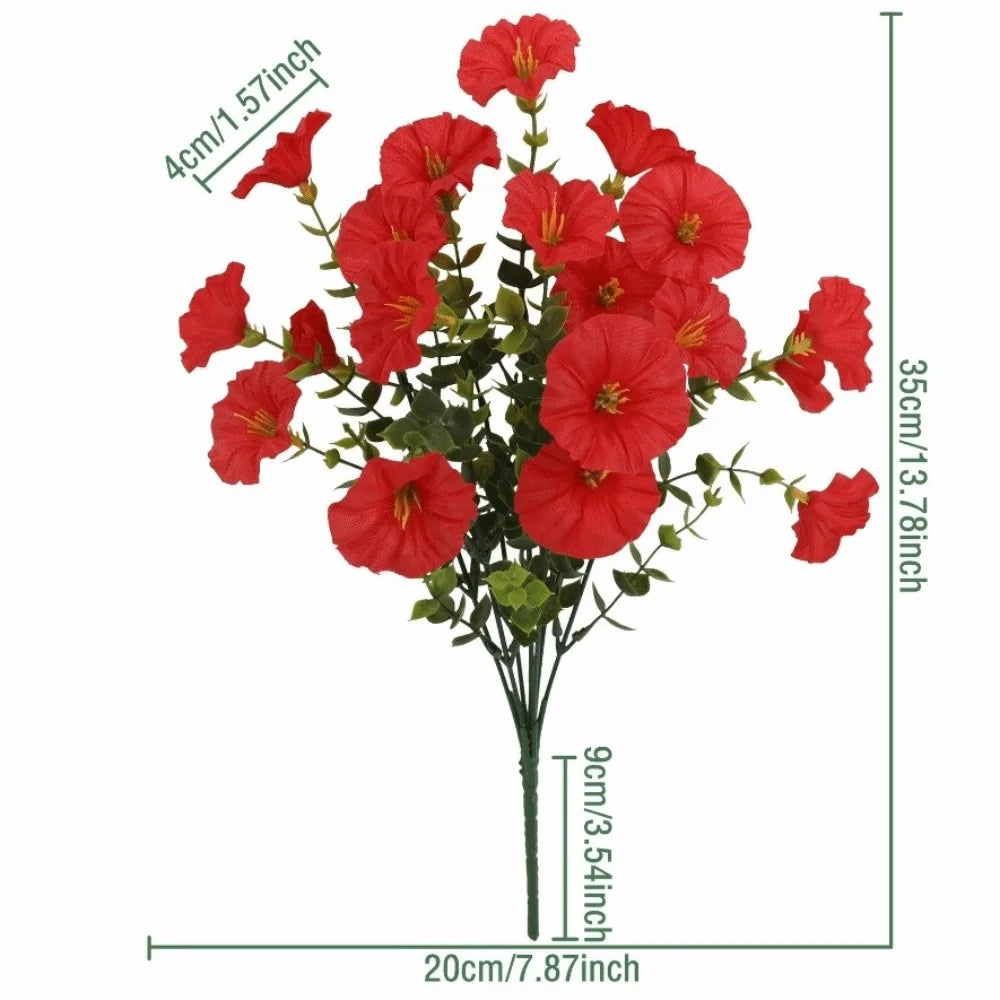 A bouquet of artificial red pansy flowers with green eucalyptus stems.