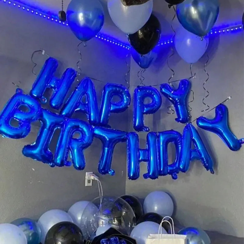 A blue theme party decoration featuring large blue foil balloons spelling out Happy Birthday
