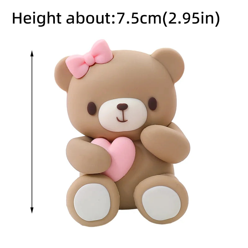 A cute, light brown teddy bear with pink accents and a heart design.