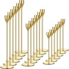 A set of elegant gold metal candle holders, featuring tall, slender cylindrical stands.