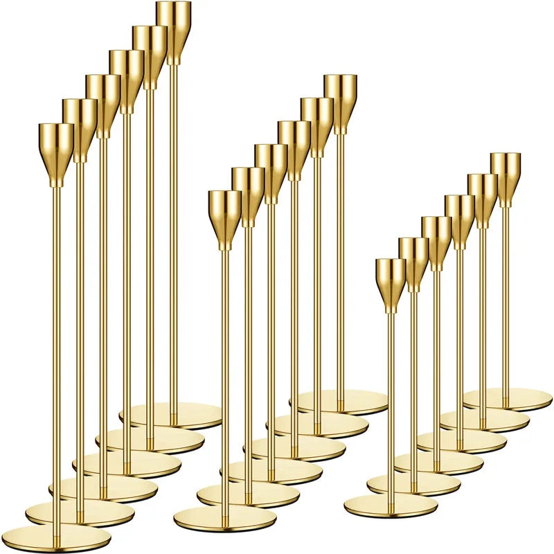A set of elegant gold metal candle holders, featuring tall, slender cylindrical stands.