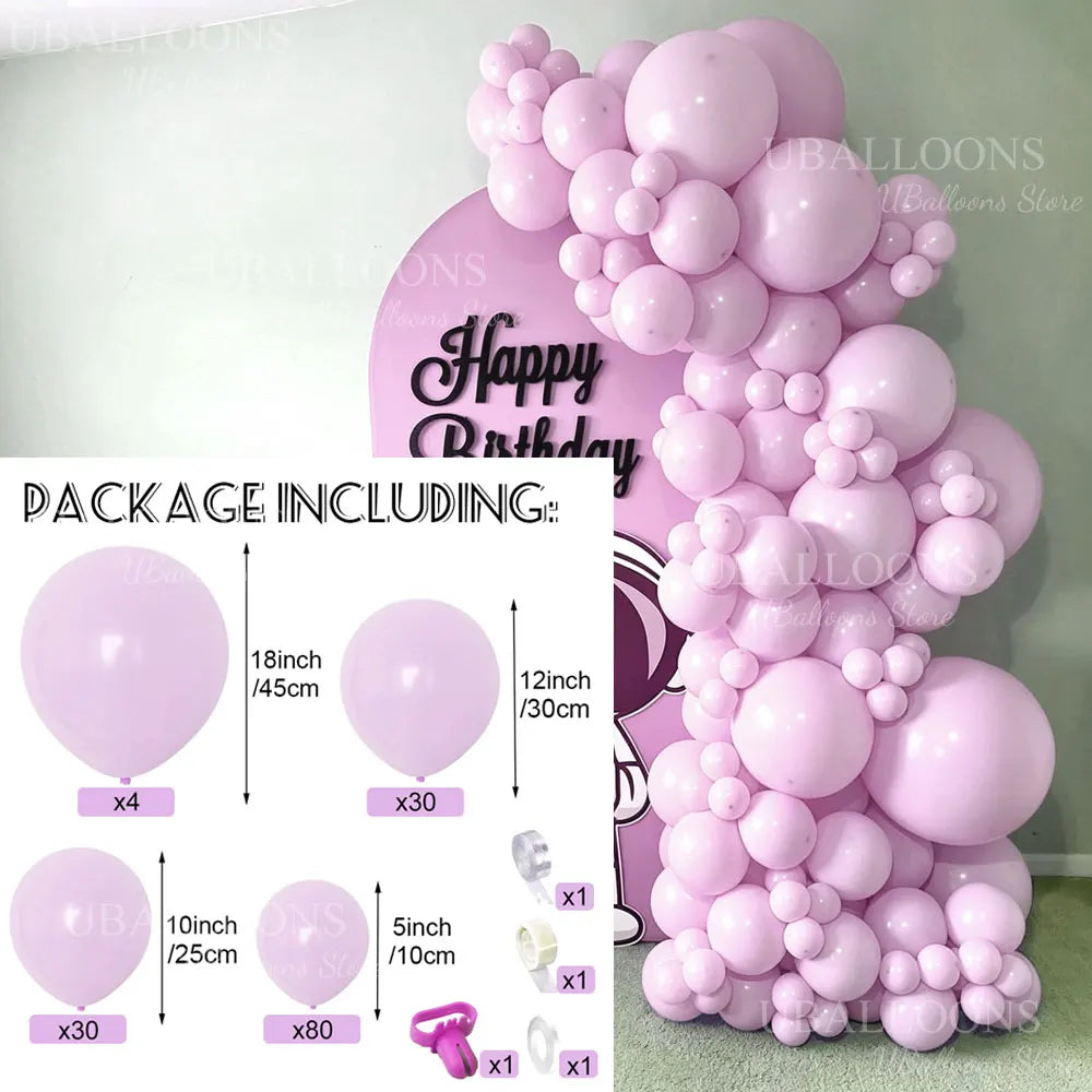 A large pink balloon arch display featuring various sizes of balloons and accessories for parties and showers.