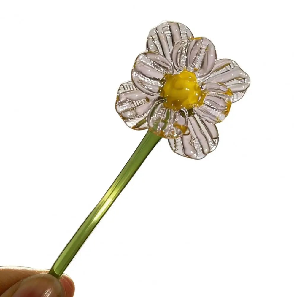 Handcrafted blue glass flower sculpture with a yellow center and green stem