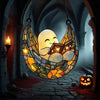 A hanging decoration shaped like a smiling ghost reading an open book, displayed in a dark, arched hallway with candles and p
