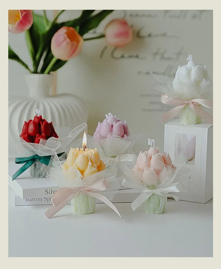A collection of artisan tulip bouquets in various colors, including pink and orange, displayed alongside soy wax candles.