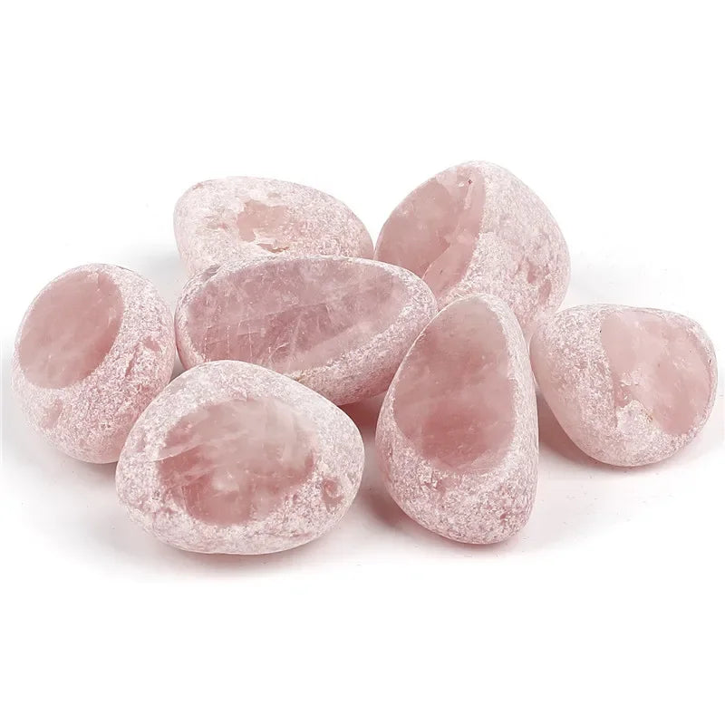 A collection of tumbled rose quartz crystals in various shades and sizes.