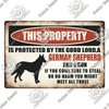 A vintage metal sign with text warning that the property is protected by a German Shepherd and gun.