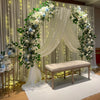 A floral archway decoration featuring white and blue roses and greenery for an event backdrop.