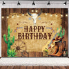 A rustic western backdrop featuring a wooden barn door, cacti, a skull, and cowboy boots.