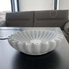 A white lotus leaf resin decorative bowl is displayed on a dark table.