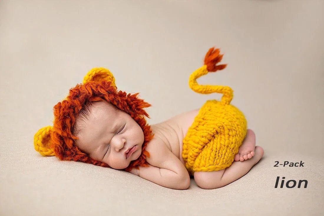 A newborn baby is sleeping wearing a handcrafted lion crochet outfit set with orange and yellow textures.